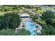 Overhead shot of community pool and clubhouse with lush trees and landscaping in a beautiful community at 10459 Ladybug Cove, Parrish, FL 34219