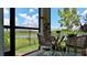 Inviting screened patio with cozy seating and a picturesque view of the serene lake and lush landscaping at 10459 Ladybug Cove, Parrish, FL 34219