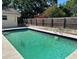 Refreshing in-ground pool surrounded by a concrete deck, perfect for outdoor relaxation and summer fun at 110 Pine Ave, Osprey, FL 34229