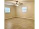 Comfortable bedroom with ample natural light, featuring tile flooring and a ceiling fan for added comfort at 110 Pine Ave, Osprey, FL 34229