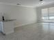 Sunlit living space showcases modern flooring and a convenient breakfast bar, ideal for entertaining and daily living at 110 Pine Ave, Osprey, FL 34229