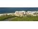 Stunning aerial view of beachfront condo buildings with lush greenery and ocean views at 1104 Benjamin Franklin Dr # 519, Sarasota, FL 34236