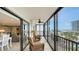 Spacious screened balcony featuring cozy seating, ceiling fan, and picturesque views of the ocean and the city at 1104 Benjamin Franklin Dr # 519, Sarasota, FL 34236