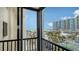 Balcony view showcasing the ocean, palm trees, and nearby buildings at 1104 Benjamin Franklin Dr # 519, Sarasota, FL 34236