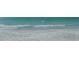 White sandy beach with clear turquoise water and gentle waves at 1104 Benjamin Franklin Dr # 519, Sarasota, FL 34236