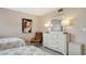 Bedroom featuring two twin beds, a white dresser and modern artwork at 1104 Benjamin Franklin Dr # 519, Sarasota, FL 34236