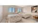 Light and bright bedroom with two twin beds, white flooring and two windows at 1104 Benjamin Franklin Dr # 519, Sarasota, FL 34236