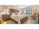 Comfortable bedroom with wood floors, a large window, and stylish furnishings at 1104 Benjamin Franklin Dr # 519, Sarasota, FL 34236