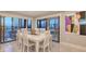 Elegant dining room with seating for eight, marble tile flooring, and a balcony entrance, perfect for entertaining at 1104 Benjamin Franklin Dr # 519, Sarasota, FL 34236