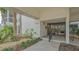 Inviting condo entrance with well-manicured landscaping, tiled walkway, and secure entry at 1104 Benjamin Franklin Dr # 519, Sarasota, FL 34236