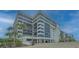 Modern condo exterior with large windows, palm trees, and ample parking at 1104 Benjamin Franklin Dr # 519, Sarasota, FL 34236