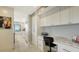 Hallway boasts built-in desk and storage with sleek white cabinets and marble countertops at 1104 Benjamin Franklin Dr # 519, Sarasota, FL 34236