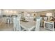 Open-concept kitchen and dining area with sleek white cabinetry, tile floors, and a seamless flow to the living room at 1104 Benjamin Franklin Dr # 519, Sarasota, FL 34236