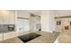 Kitchen island featuring granite countertops, a stovetop, and modern appliances at 1104 Benjamin Franklin Dr # 519, Sarasota, FL 34236