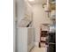 Stacked Washer and Dryer in laundry room with storage and shelving at 1104 Benjamin Franklin Dr # 519, Sarasota, FL 34236
