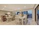 Open living and dining area with marble floors, contemporary furnishings, and views from the balcony at 1104 Benjamin Franklin Dr # 519, Sarasota, FL 34236
