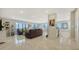 Bright, open living room featuring floor-to-ceiling windows, tile floors, and modern decor at 1104 Benjamin Franklin Dr # 519, Sarasota, FL 34236