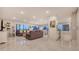 Bright, open-concept living room featuring tile floors, a large sofa, and floor to ceiling windows offering beautiful views at 1104 Benjamin Franklin Dr # 519, Sarasota, FL 34236