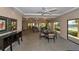 Community lounge with a table, buffet, and sliding glass doors with a view at 1104 Benjamin Franklin Dr # 519, Sarasota, FL 34236