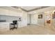 Bright office space with white built-in desk, storage, and tile floors, offering a functional workspace at 1104 Benjamin Franklin Dr # 519, Sarasota, FL 34236