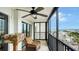 Cozy balcony featuring a chair, table, ceiling fan and waterfront views at 1104 Benjamin Franklin Dr # 519, Sarasota, FL 34236