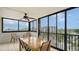Enclosed patio featuring tile floors, ceiling fan and a beautiful outdoor view at 1104 Benjamin Franklin Dr # 519, Sarasota, FL 34236