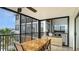 Enclosed patio with a dining table, tile floors, and balcony access at 1104 Benjamin Franklin Dr # 519, Sarasota, FL 34236