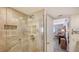 Bathroom featuring a glass-enclosed shower with neutral tile and a grab bar at 1104 Benjamin Franklin Dr # 519, Sarasota, FL 34236