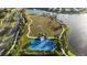Aerial view showcases community basketball court, lake, gazebo, and landscaped grounds at 11252 Fieldstone Dr, Palmetto, FL 34221