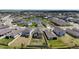 Community aerial view features a scenic pond, well-maintained homes, and ample green space at 11252 Fieldstone Dr, Palmetto, FL 34221