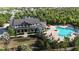 Aerial view features community clubhouse, pool, lounge chairs, palm trees, and landscaping at 11252 Fieldstone Dr, Palmetto, FL 34221