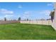 View of a spacious backyard with a well-maintained lawn and a privacy fence at 11252 Fieldstone Dr, Palmetto, FL 34221