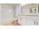 Bathroom with double vanity, a bathtub and shower combination and white cabinets at 11252 Fieldstone Dr, Palmetto, FL 34221
