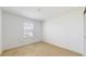Bright bedroom with neutral carpet, a single window, and a smooth, white ceiling at 11252 Fieldstone Dr, Palmetto, FL 34221