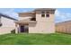 Exterior view of the home showcasing the lawn and sliding glass doors at 11252 Fieldstone Dr, Palmetto, FL 34221