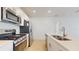 Contemporary kitchen with stainless steel appliances, white cabinets, and quartz countertops at 11252 Fieldstone Dr, Palmetto, FL 34221