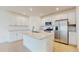 Modern kitchen featuring white cabinets, stainless steel appliances, and a center island at 11252 Fieldstone Dr, Palmetto, FL 34221