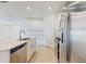 Bright kitchen with stainless steel appliances, white cabinets, and island with a sink at 11252 Fieldstone Dr, Palmetto, FL 34221
