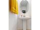 Stylish powder room featuring a pedestal sink, oval mirror, and a decorative towel creating a welcoming space at 11252 Fieldstone Dr, Palmetto, FL 34221