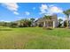 Expansive backyard featuring a lush lawn and screened-in lanai, perfect for outdoor entertaining at 11420 Golden Bay Pl, Bradenton, FL 34211