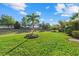 Expansive green backyard featuring lush grass, mature trees, and meticulous landscaping at 11420 Golden Bay Pl, Bradenton, FL 34211