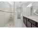 This bathroom offers dual vanities and a walk-in shower that exudes modern luxury and convenience at 11420 Golden Bay Pl, Bradenton, FL 34211