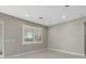 Comfortable bedroom featuring neutral tones, tile flooring, and large windows providing ample natural light at 11420 Golden Bay Pl, Bradenton, FL 34211
