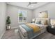 Cozy bedroom with ceiling fan, plush carpeting, and natural light, creates a relaxing atmosphere at 11420 Golden Bay Pl, Bradenton, FL 34211