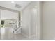 Bright hallway leading to staircase and living area with tile flooring, neutral paint, and ample space at 11420 Golden Bay Pl, Bradenton, FL 34211