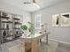 Stylish home office featuring modern desk, shelving, and natural light, perfect for a productive workspace at 11420 Golden Bay Pl, Bradenton, FL 34211