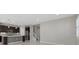 Stylish kitchen with stainless steel appliances, a central island, and a staircase leading to the upper level at 11420 Golden Bay Pl, Bradenton, FL 34211