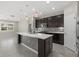 Spacious kitchen with a large center island, stainless steel appliances, and dark cabinets at 11420 Golden Bay Pl, Bradenton, FL 34211