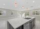 Open-concept kitchen with a quartz countertop island overlooking the living area and backyard at 11420 Golden Bay Pl, Bradenton, FL 34211