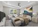 Calm main bedroom featuring tray ceilings, a ceiling fan, and natural light creates a peaceful retreat at 11420 Golden Bay Pl, Bradenton, FL 34211